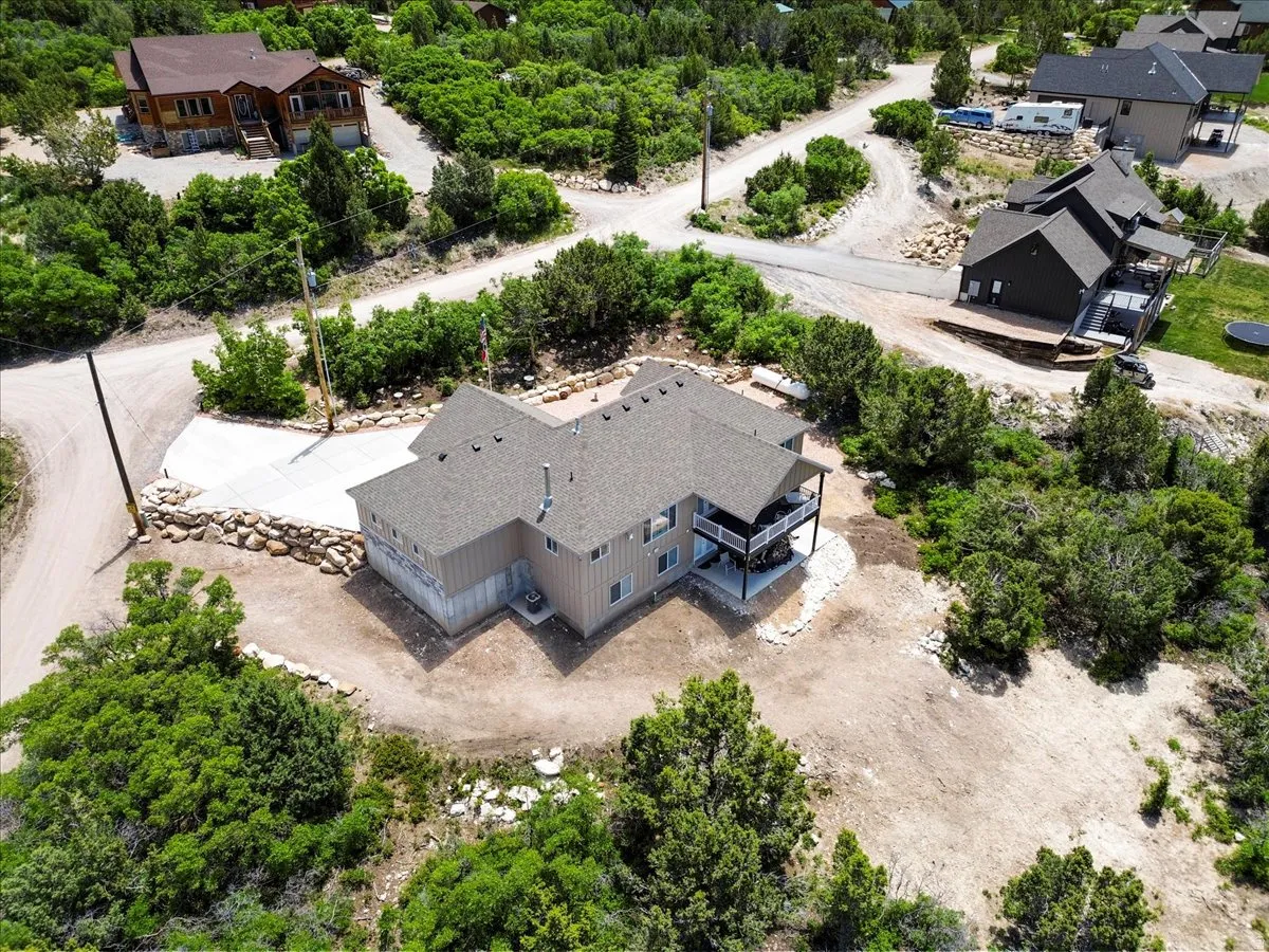 View from above of property with a tree filled landscape
