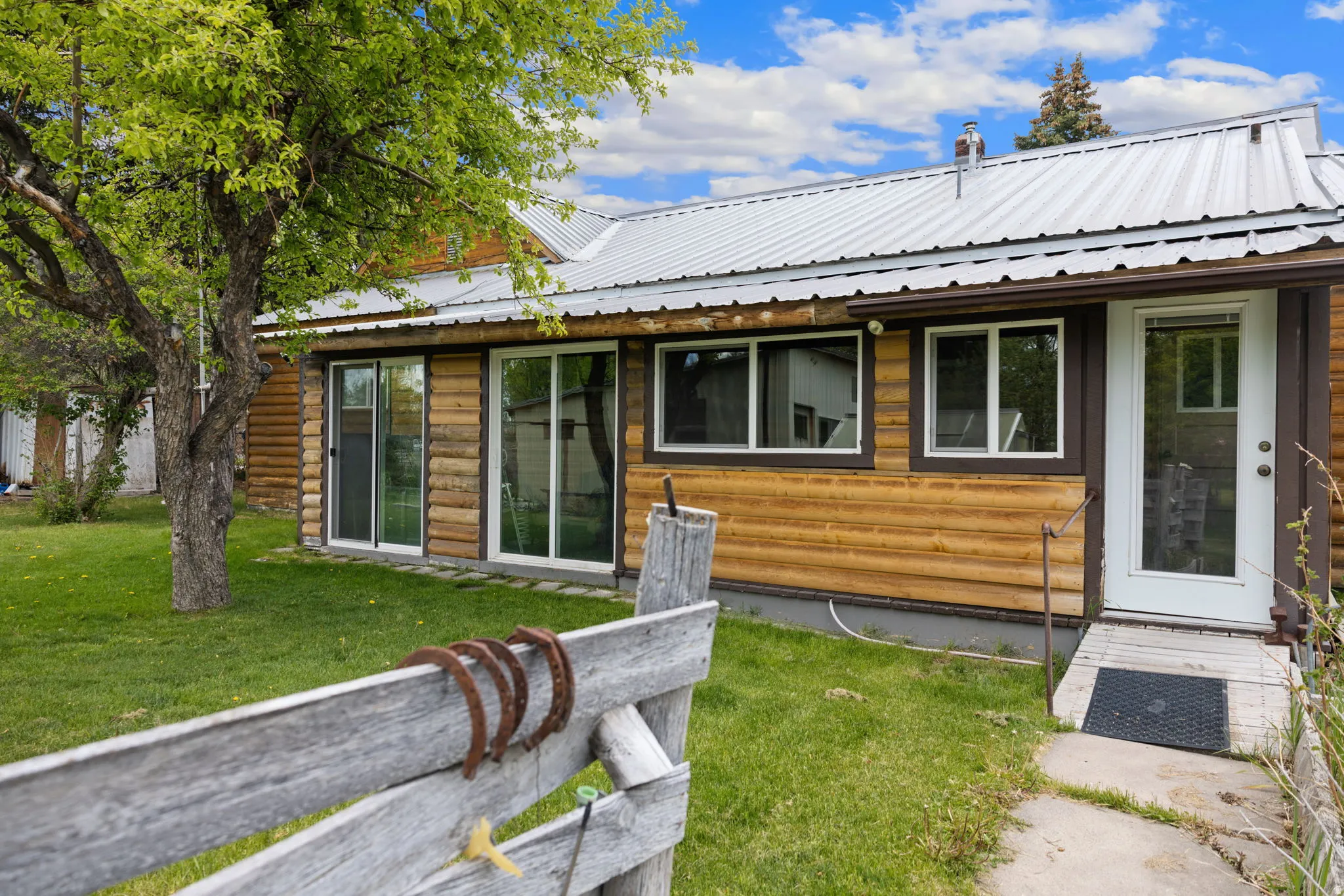 Log-style siding exterior with a metal roof