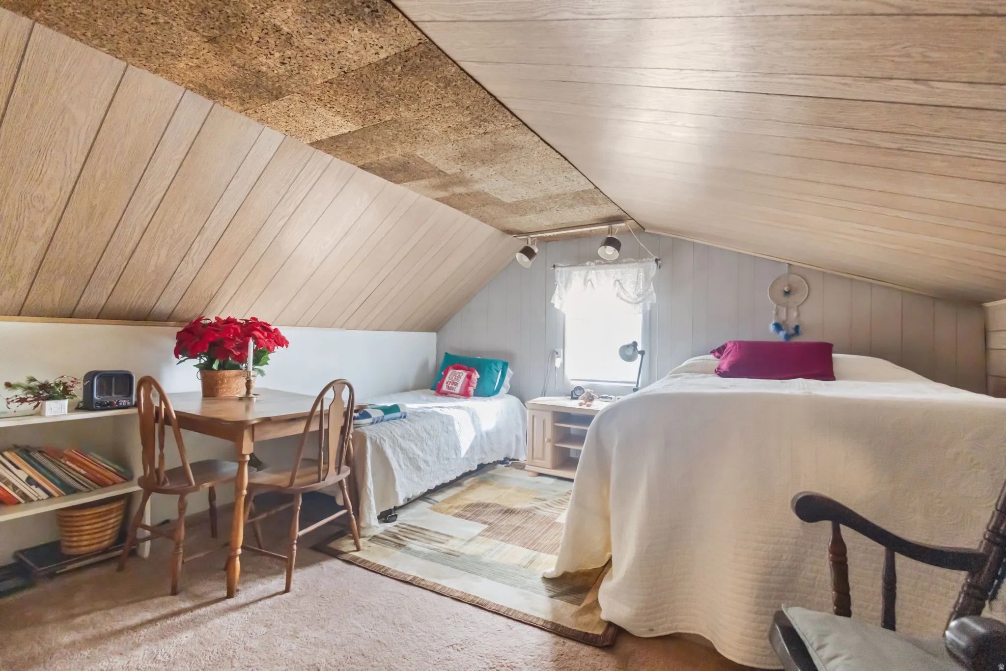 Carpeted bedroom with wood ceiling and wooden walls