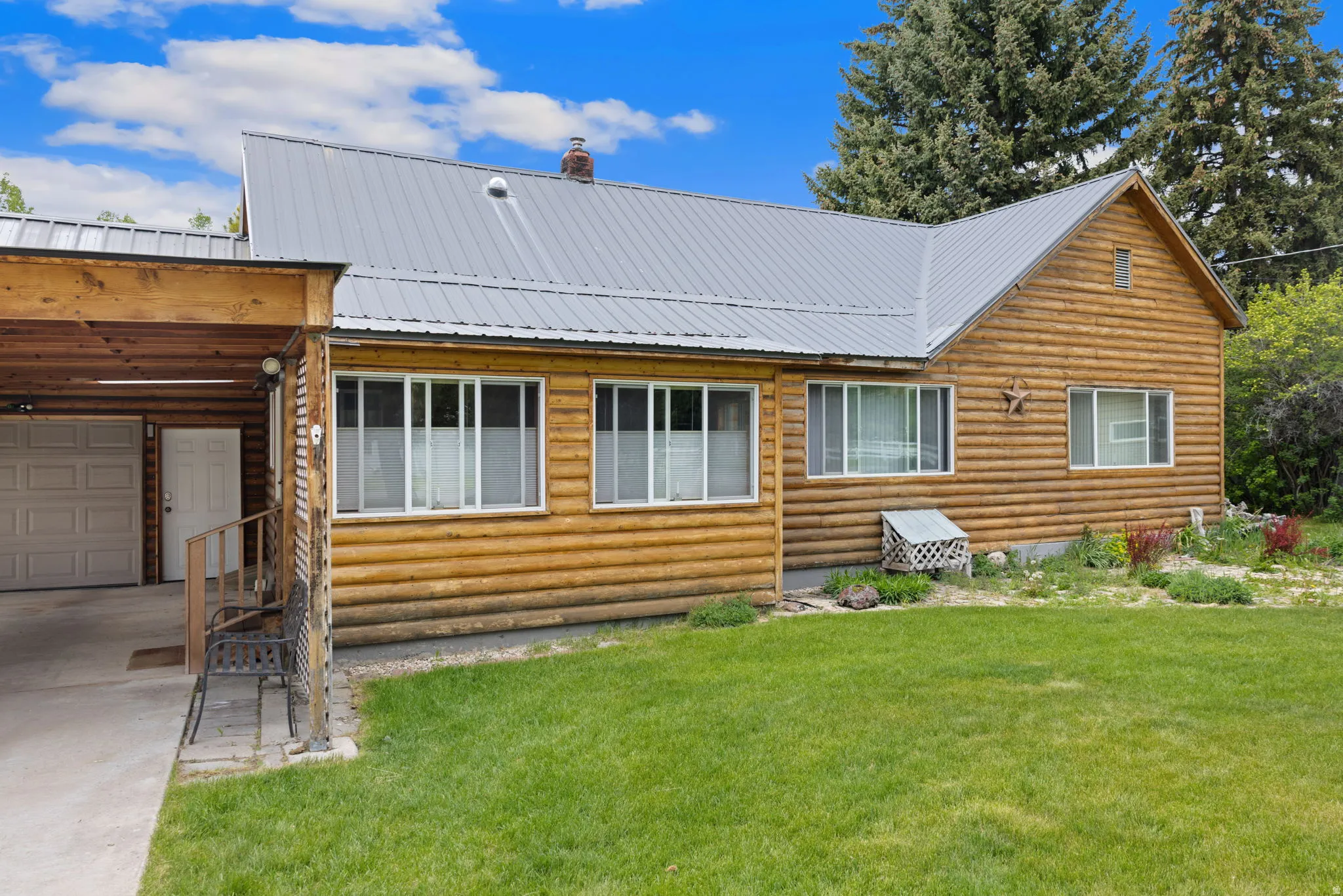 Log cabin-style exterior with a gray metal roof