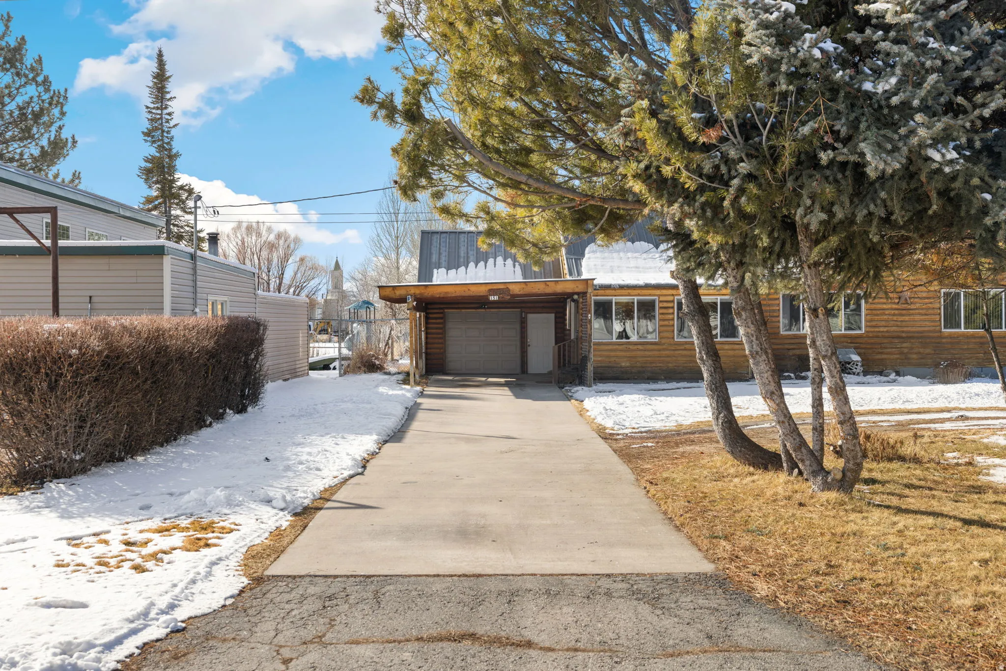 View of front of house featuring concrete driveway and an attached garage