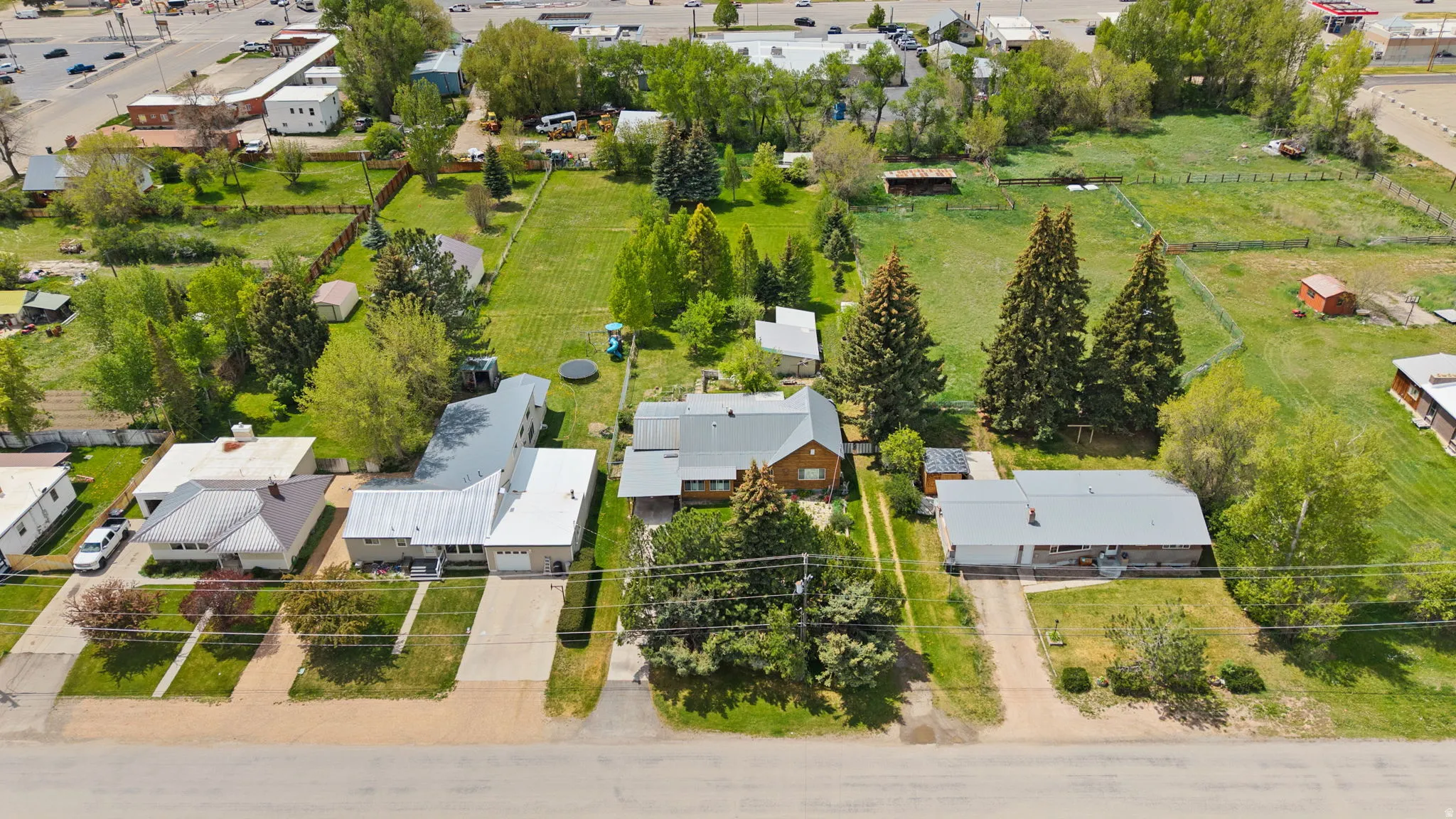 Aerial perspective showcasing multiple properties with expansive green spaces