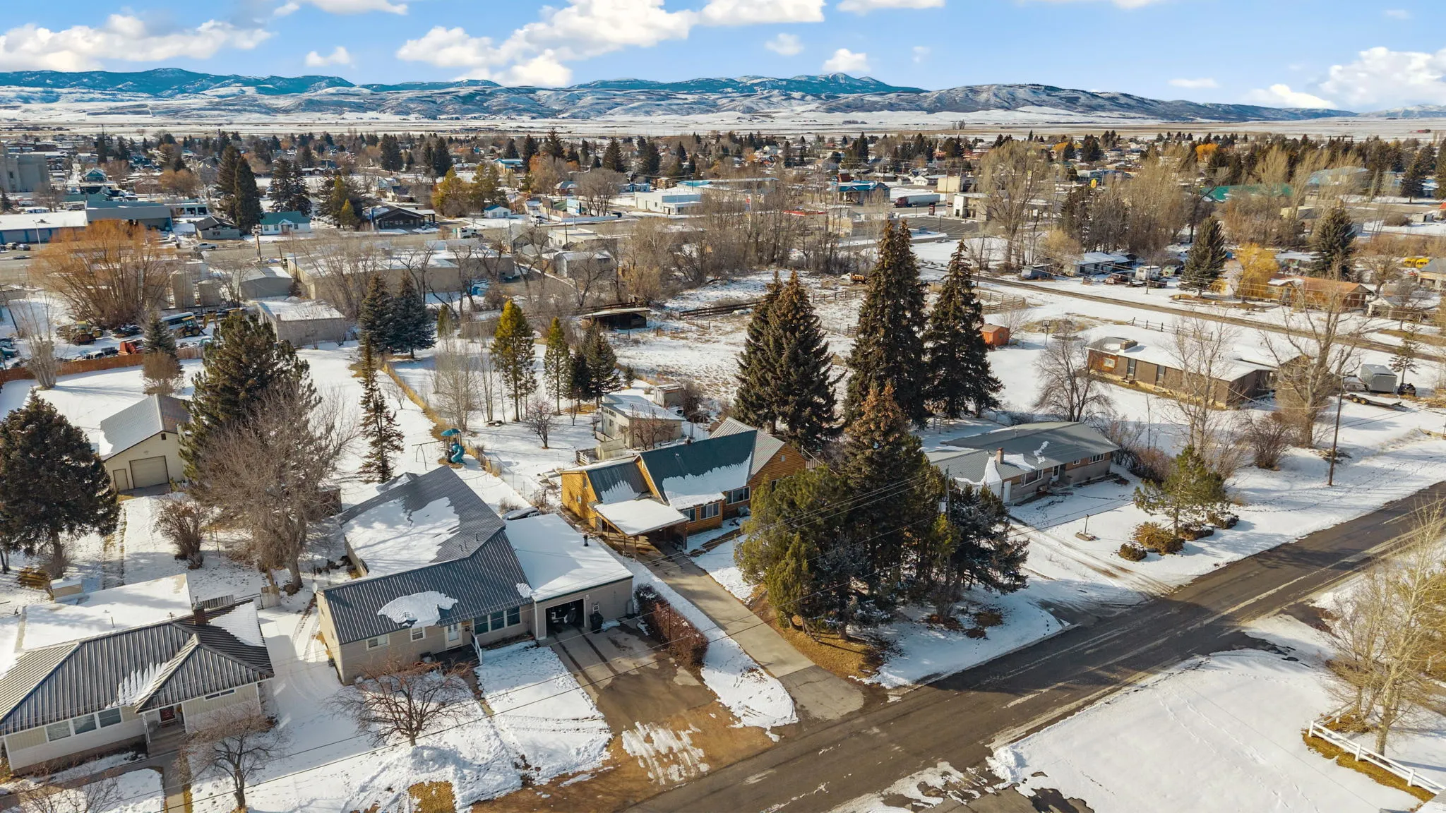 Snowy aerial view with a residential view and a mountain view