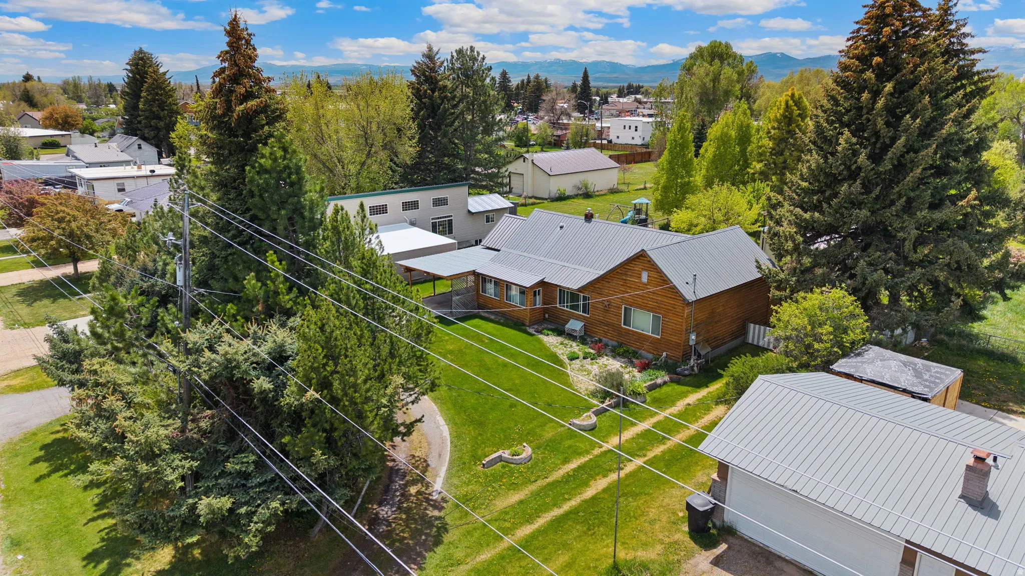 Single-story residence featuring wood siding and a metal roof