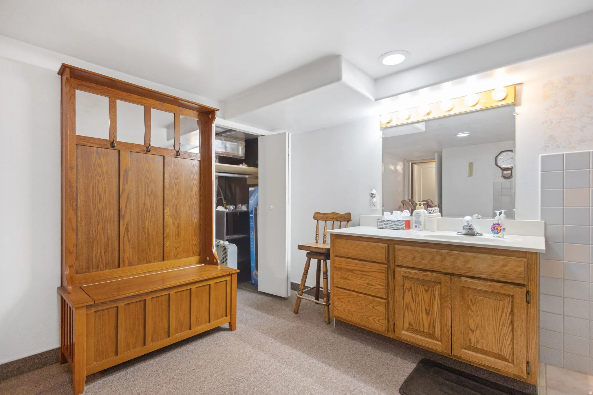 Full bathroom featuring vanity, light colored carpet, and tile walls