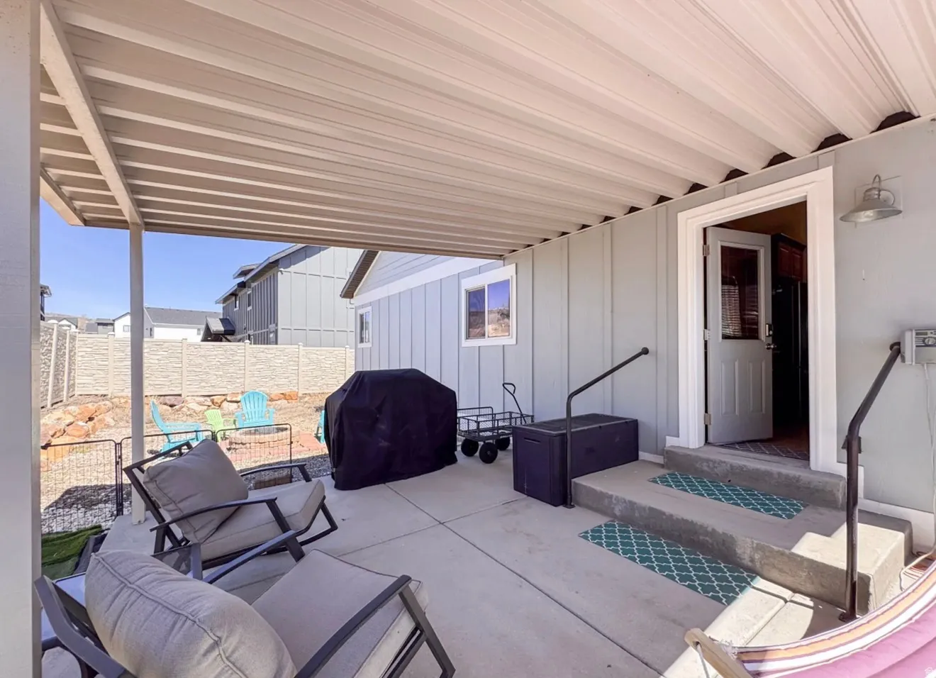View of patio with a grill
