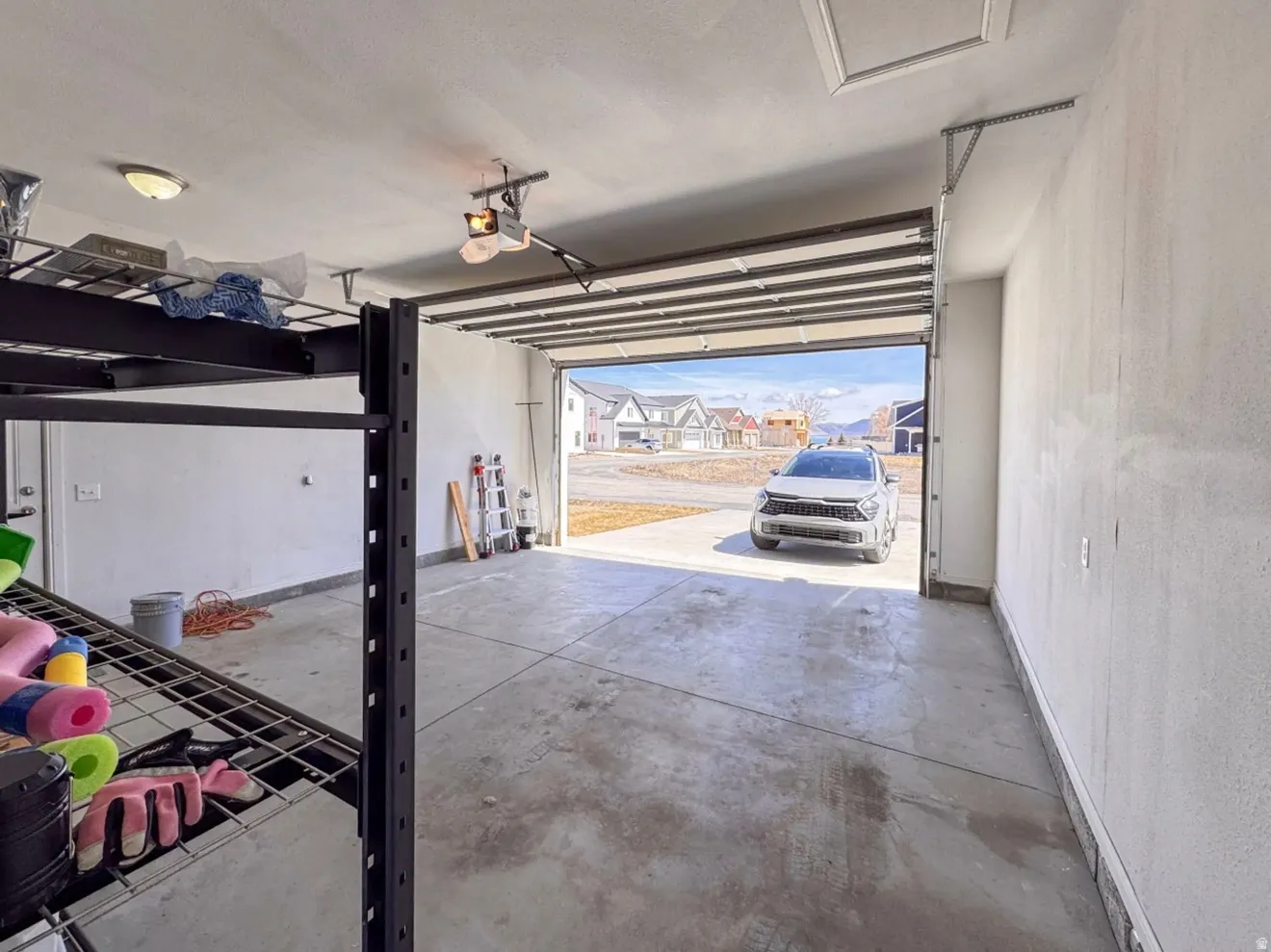 Garage featuring a residential view and a garage door opener
