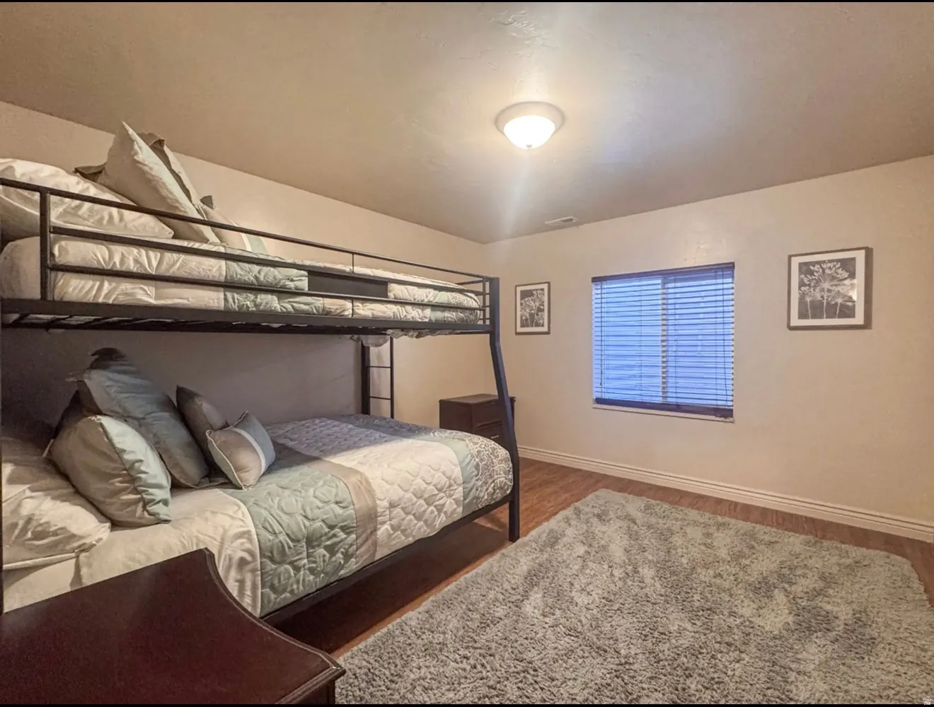 Bedroom with baseboards and wood finished floors
