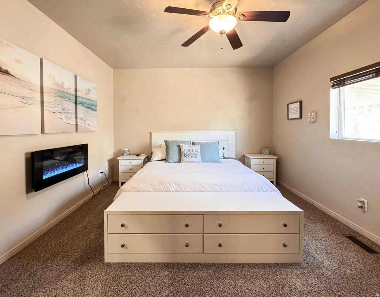 Bedroom featuring ceiling fan and dark colored carpet