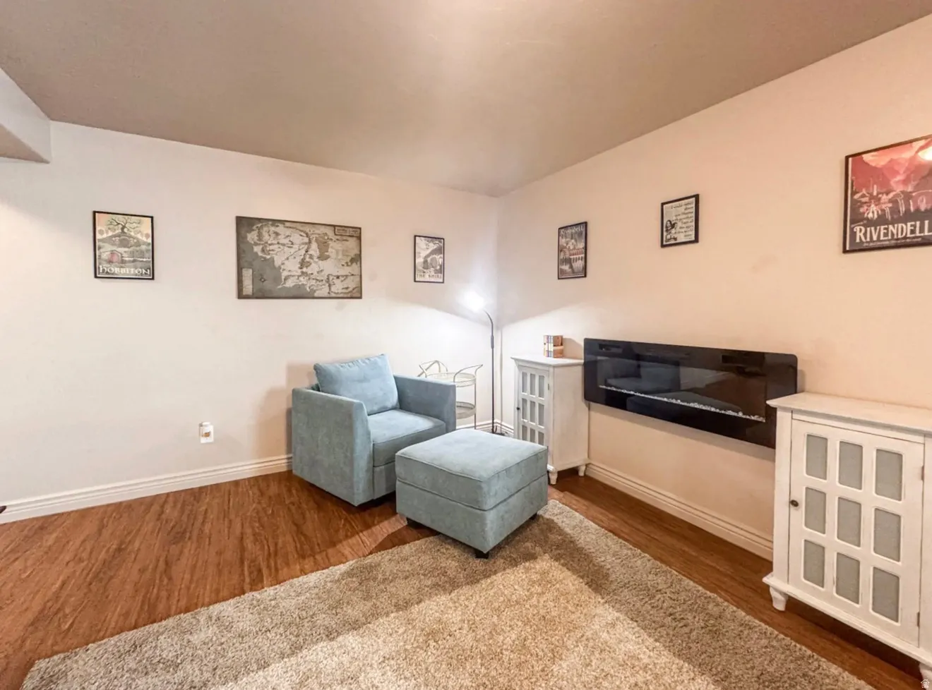 Sitting room with wood finished floors and baseboards