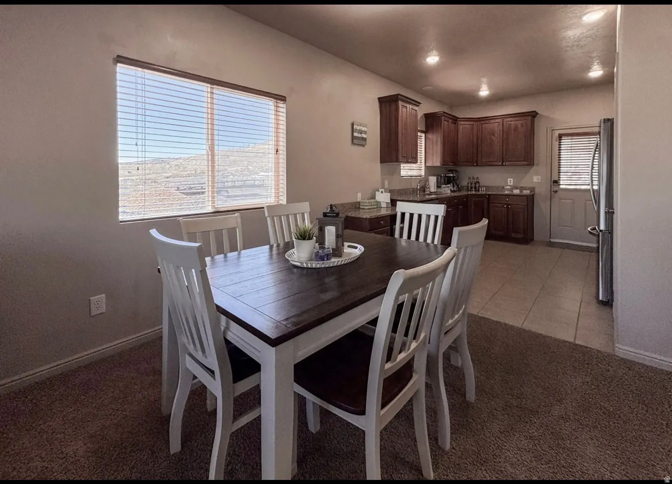 Dining area featuring healthy amount of natural light, light colored carpet, and recessed lighting
