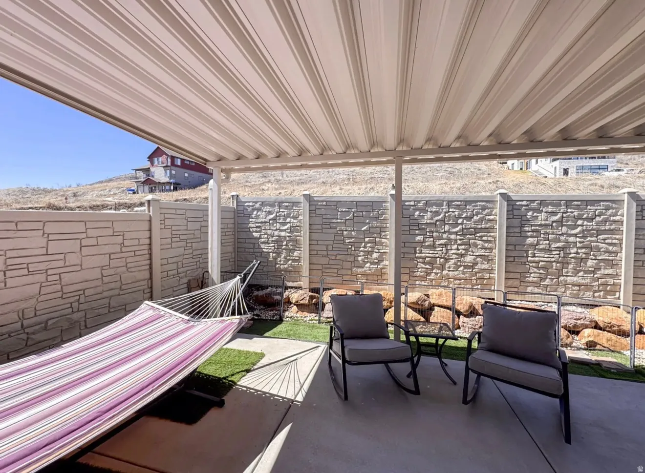 Fenced backyard with a patio area