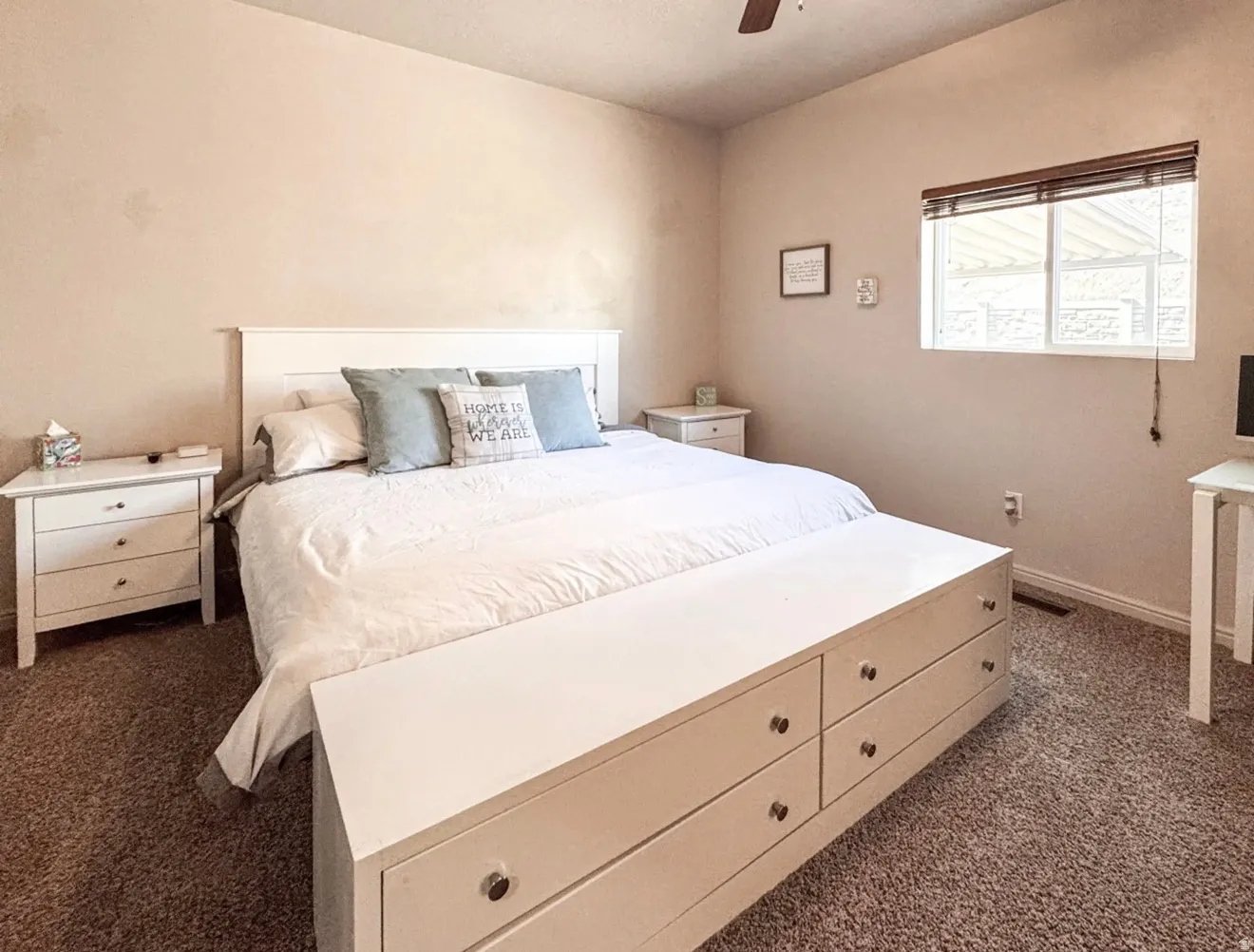 Bedroom featuring dark carpet and a ceiling fan