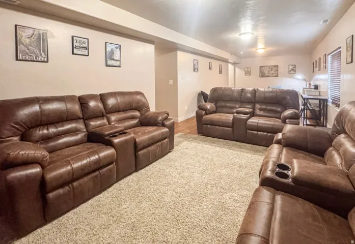 Carpeted home theater room featuring baseboards