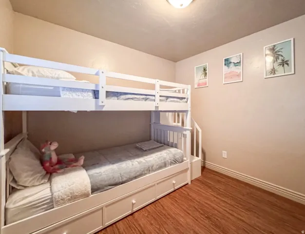 Bedroom featuring baseboards and wood finished floors
