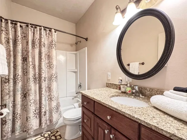 Full bath with vanity and shower / bathtub combination with curtain