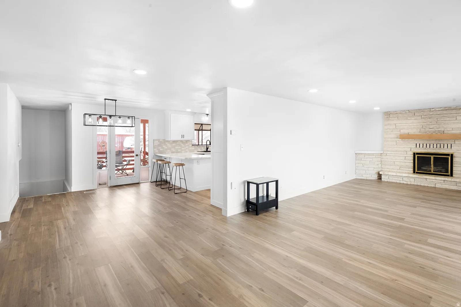 Unfurnished living room with light wood-style flooring, a fireplace, and recessed lighting