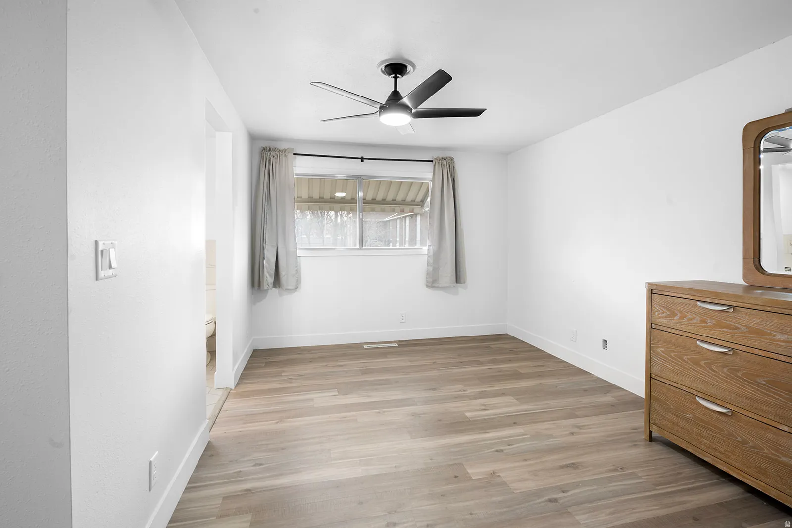 Unfurnished bedroom featuring a ceiling fan and light wood-type flooring