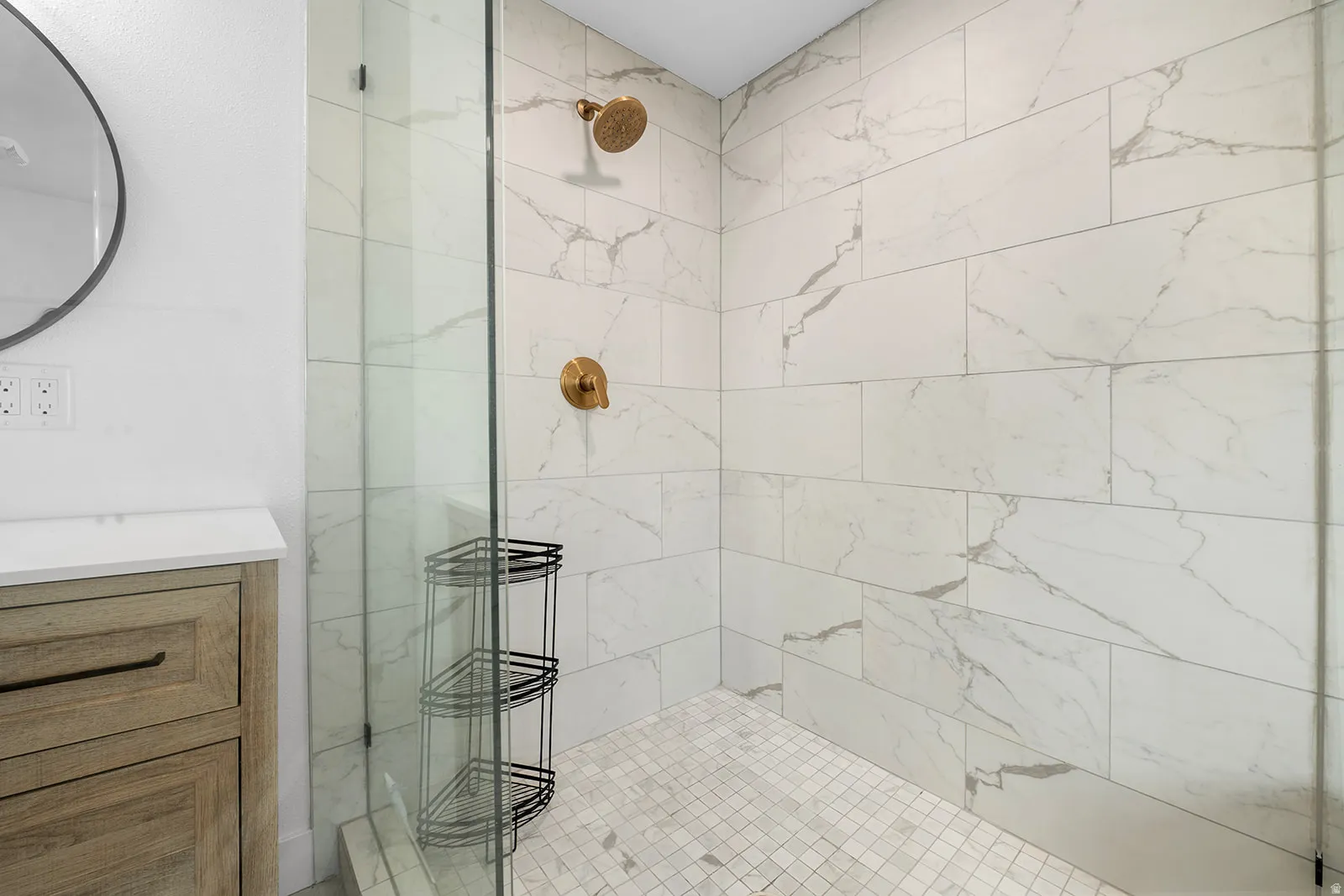 Full bath with vanity and tiled shower