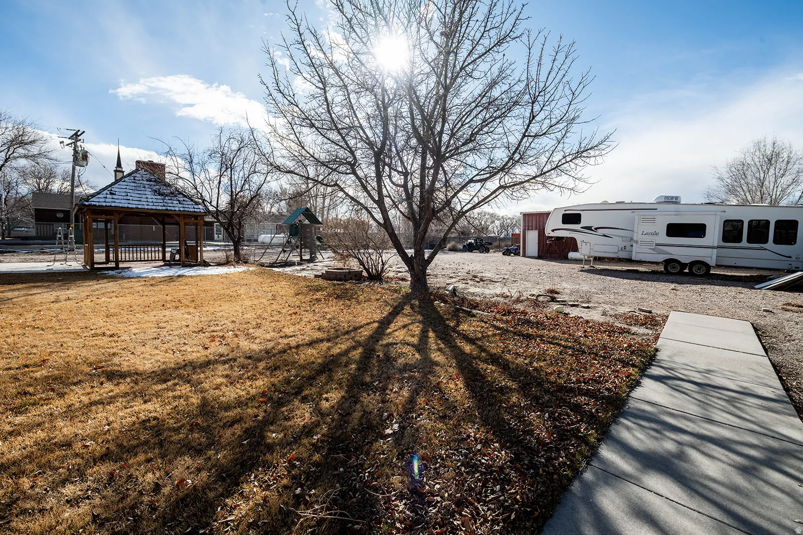 View of grassy yard featuring a gazebo and a patio