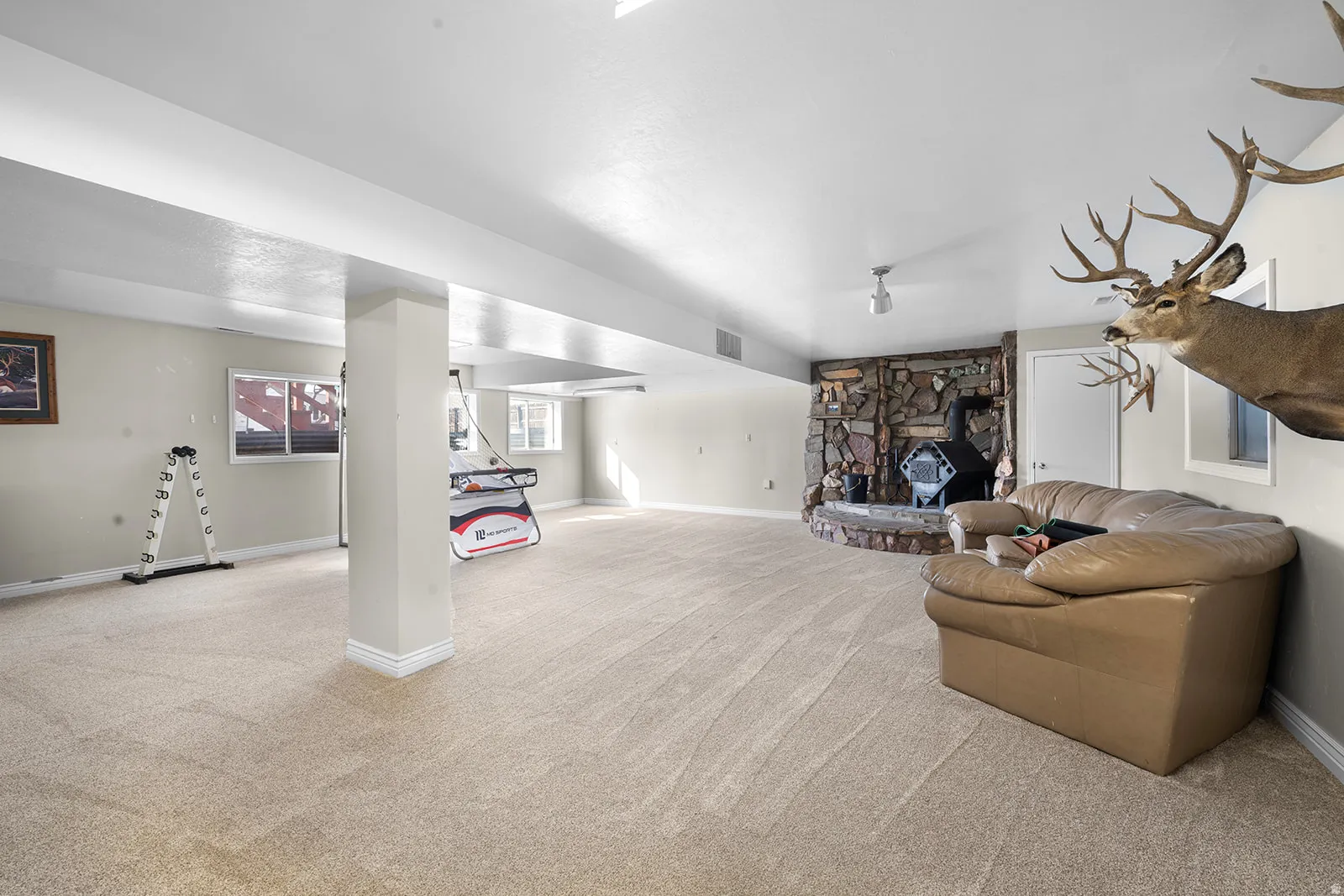 Living area with light carpet and a fireplace