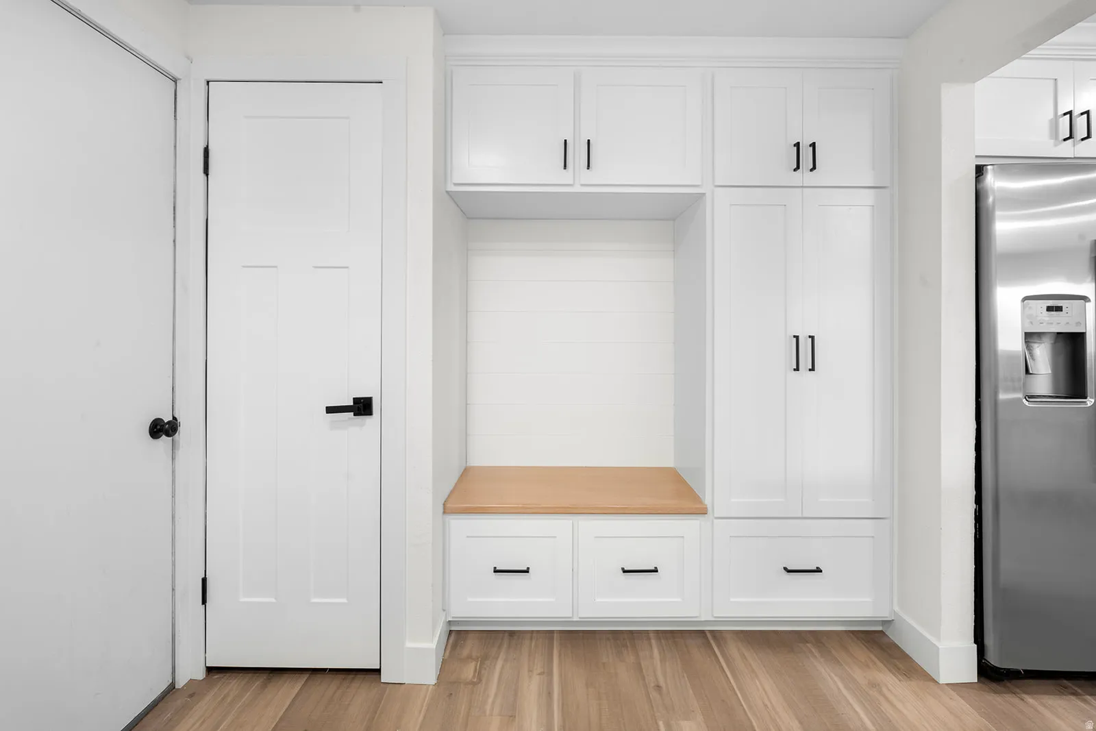 Mudroom with light wood-type flooring and baseboards