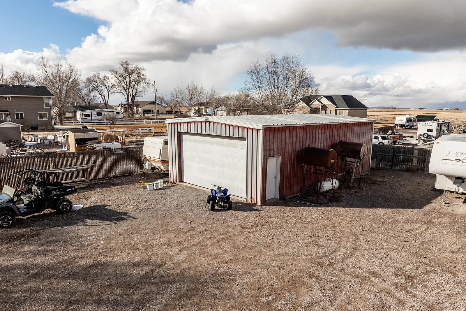 Detached garage featuring a residential view