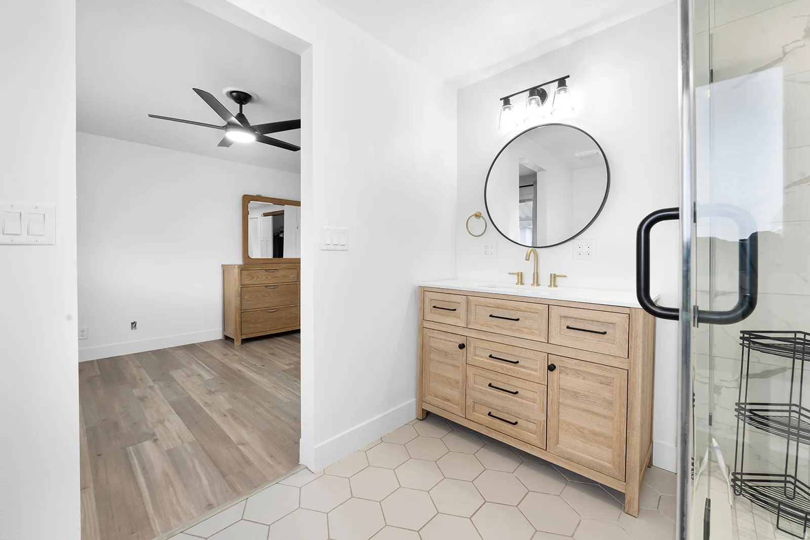 Bathroom featuring vanity, a shower stall, ceiling fan, and light tile patterned floors