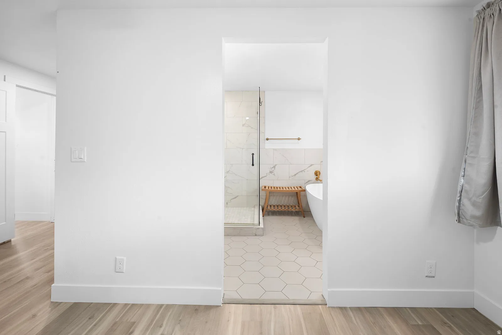 Hallway with baseboards and light wood-style floors