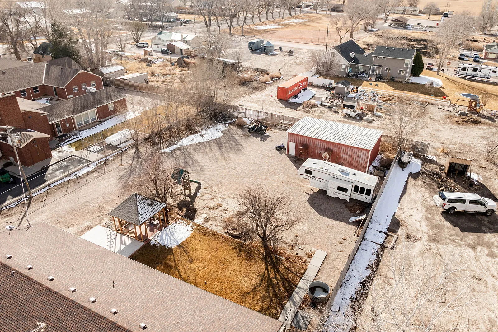 Aerial view of property and surrounding area with nearby suburban area