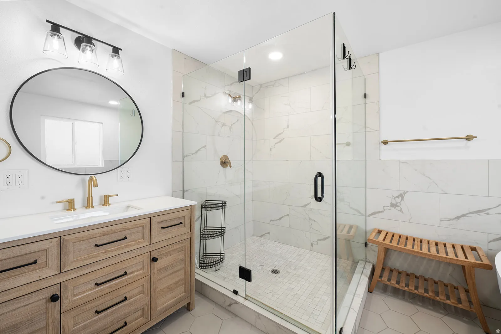 Bathroom featuring vanity, a marble finish shower, and recessed lighting