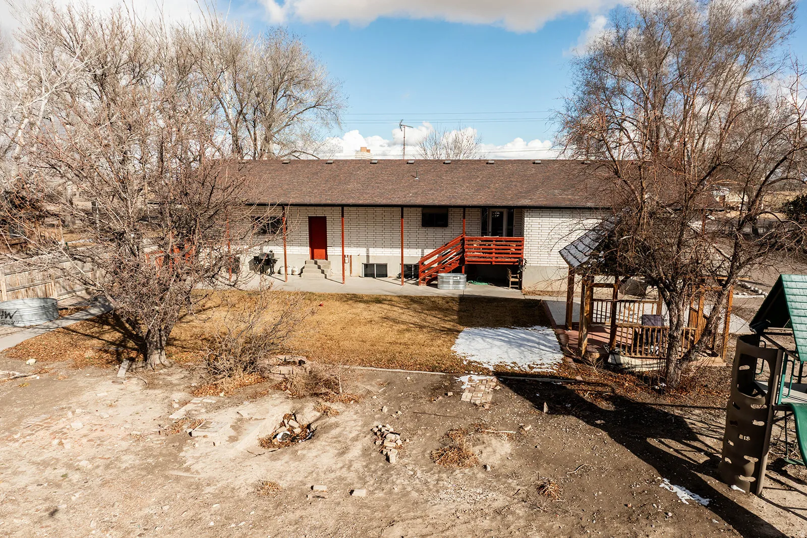 Ranch-style home with a patio area, roof with shingles, and brick siding