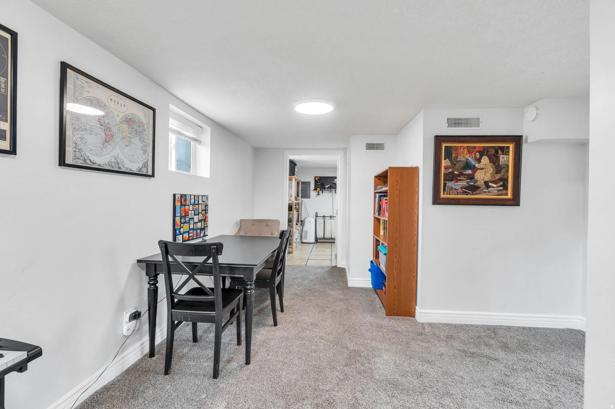 Dining room featuring light colored carpet and baseboards
