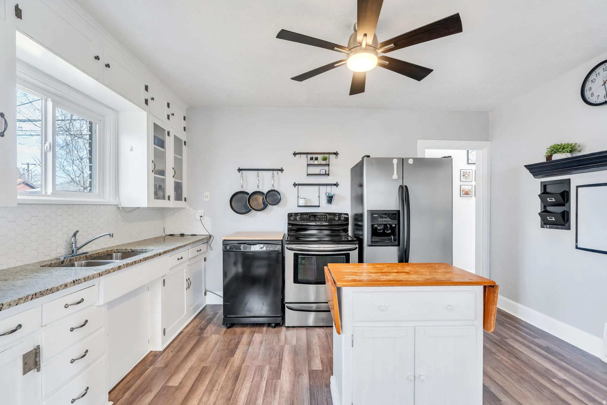 Kitchen featuring white cabinetry, stainless steel appliances, and a kitchen island