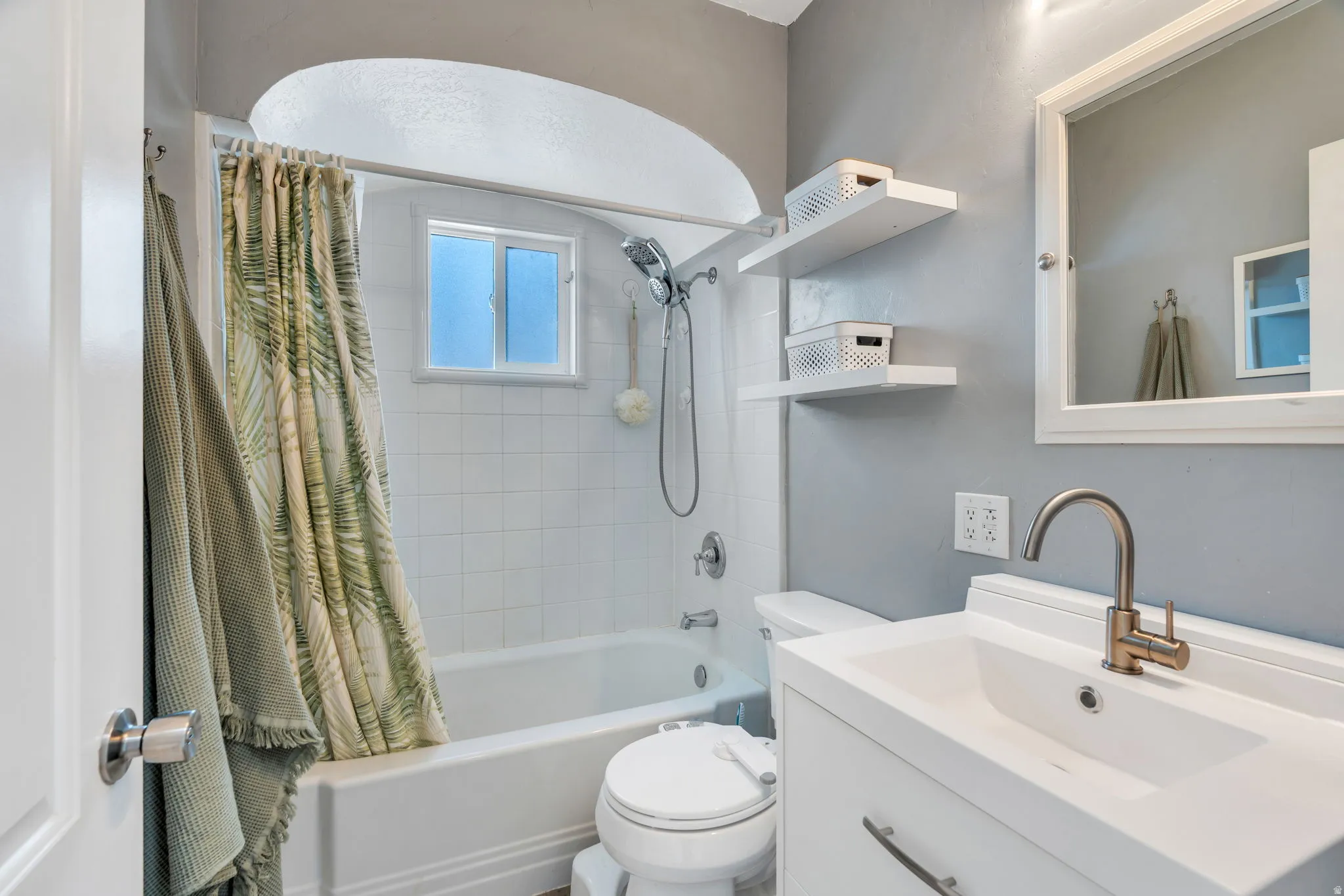 Bathroom featuring shower / tub combo with curtain and vanity
