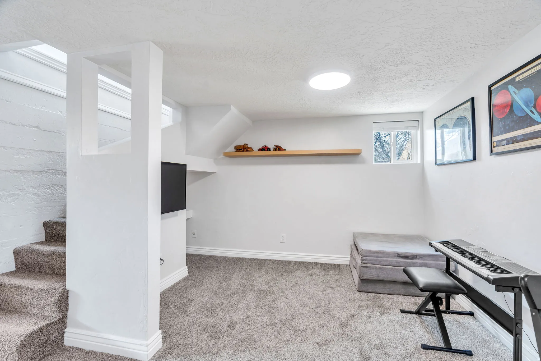 Living area with light carpet and a textured ceiling