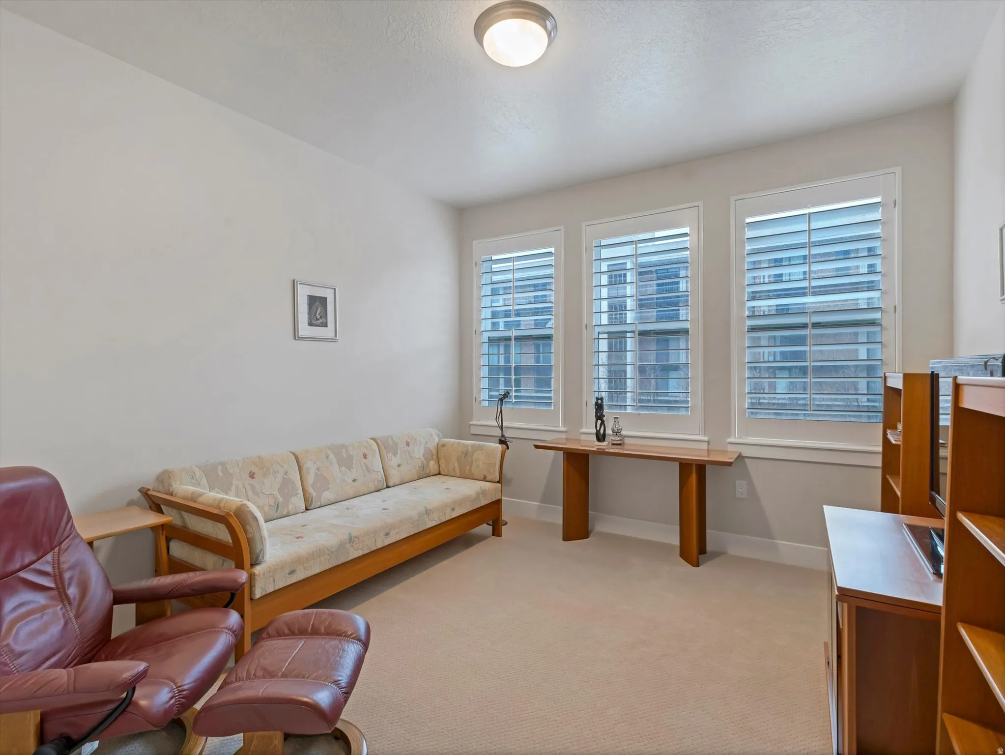 Carpeted 2nd bedroom with ample light.