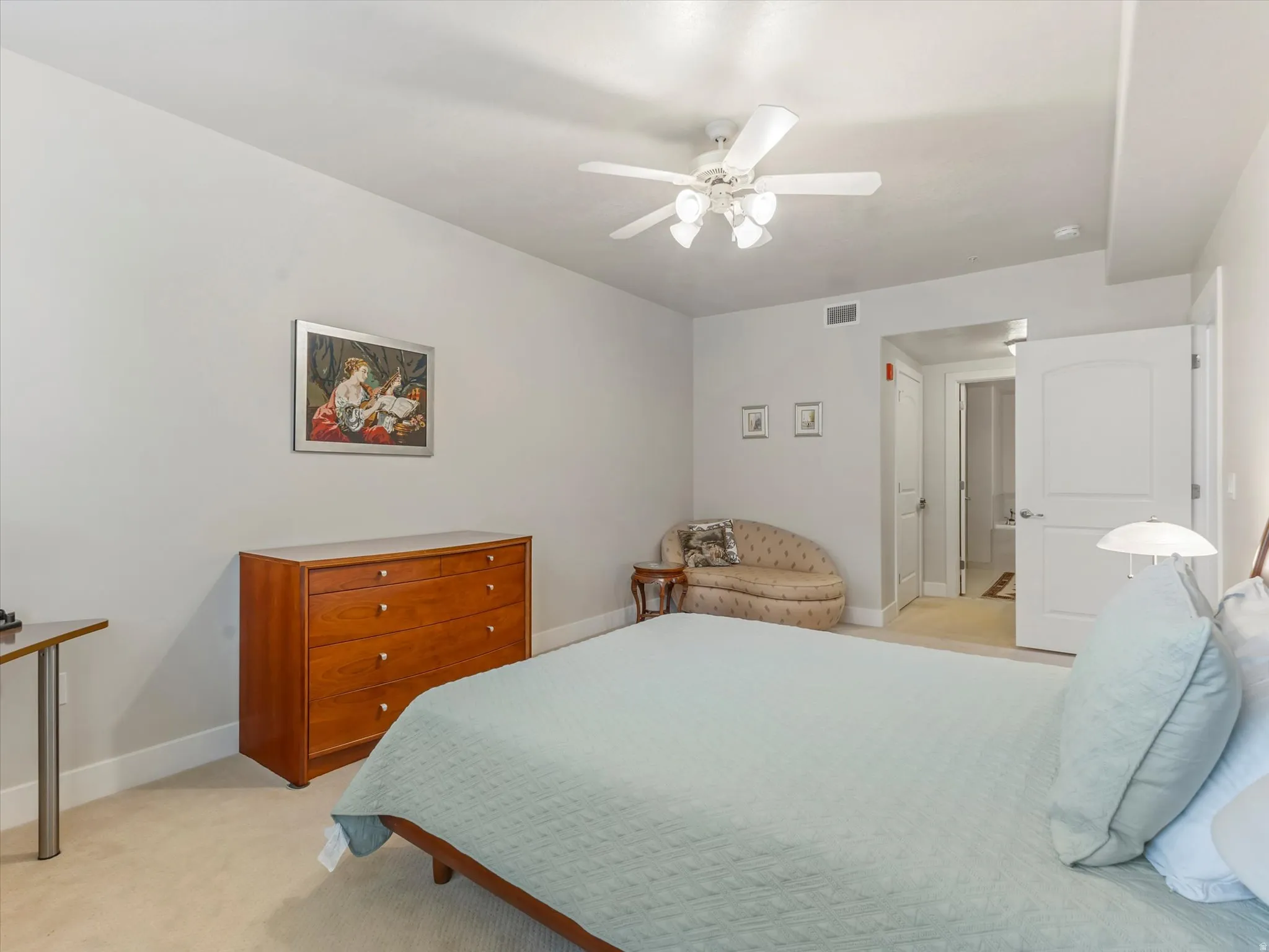 Bedroom with light carpet and a ceiling fan