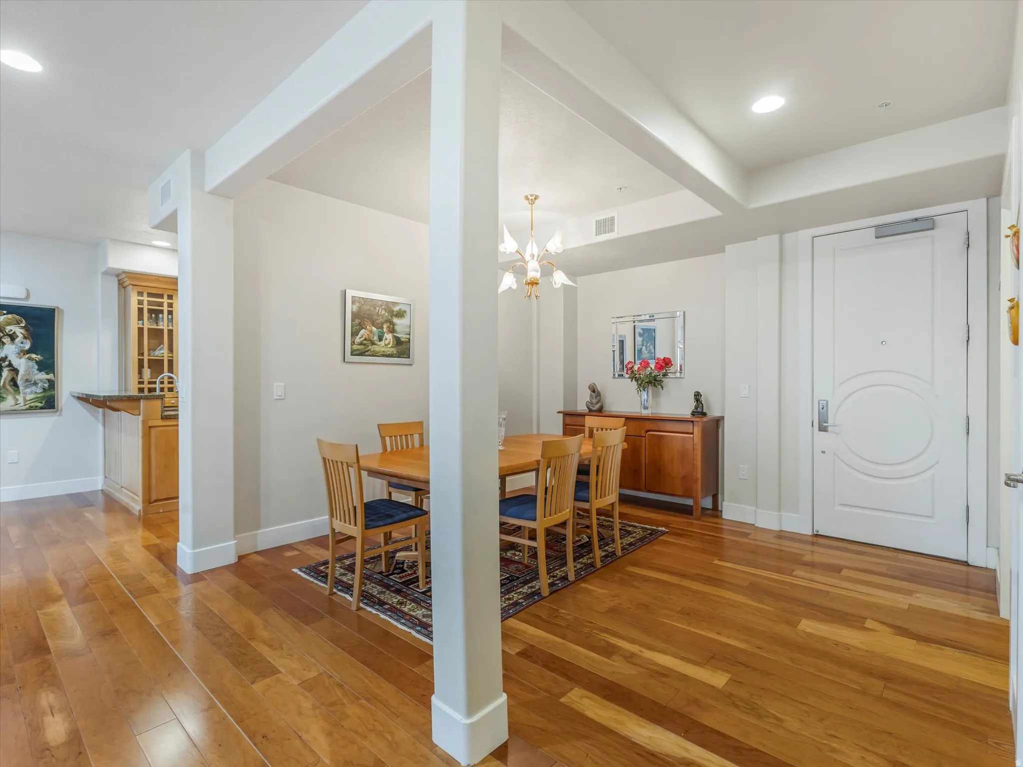 Dining room featuring light wood finished floors and suspended lighting