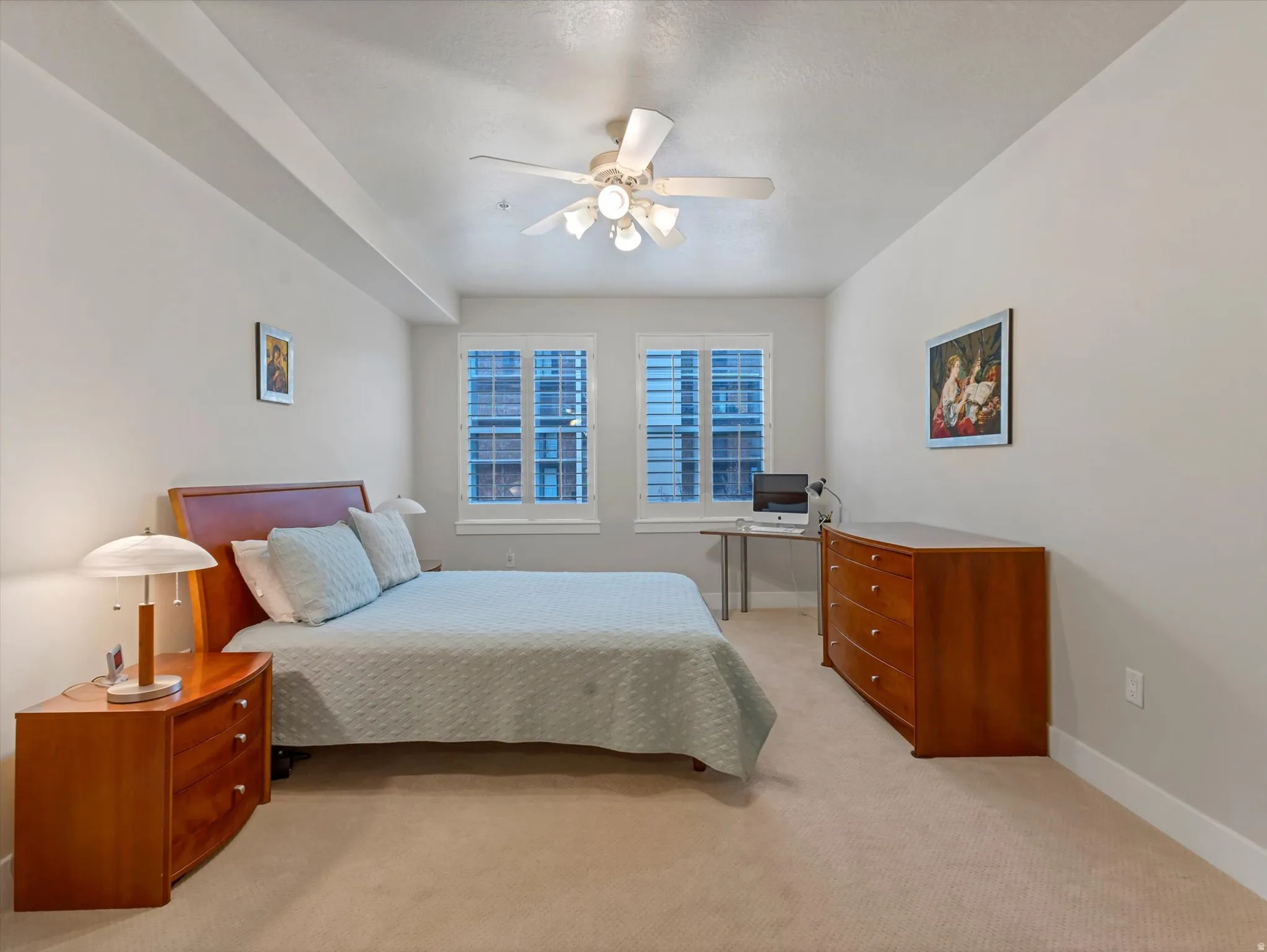 Carpeted bedroom featuring baseboards and a ceiling fan