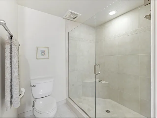 Master bathroom featuring a shower stall, european doors, recessed lighting, and tile patterned floors.