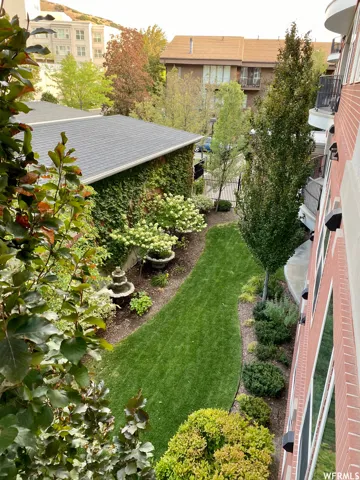 View of yard with a balcony