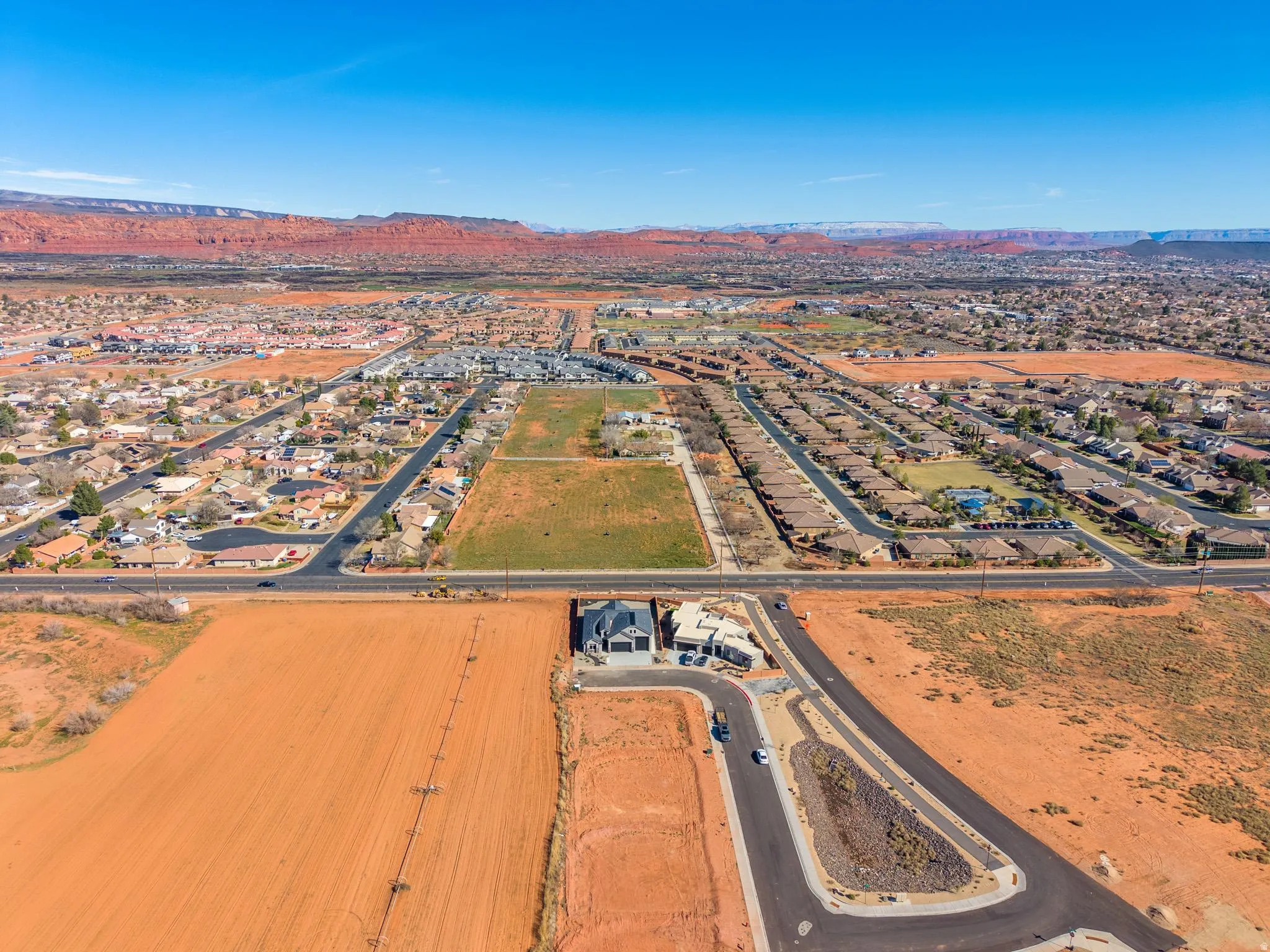 Aerial overview of property's location with mountains and nearby suburban area