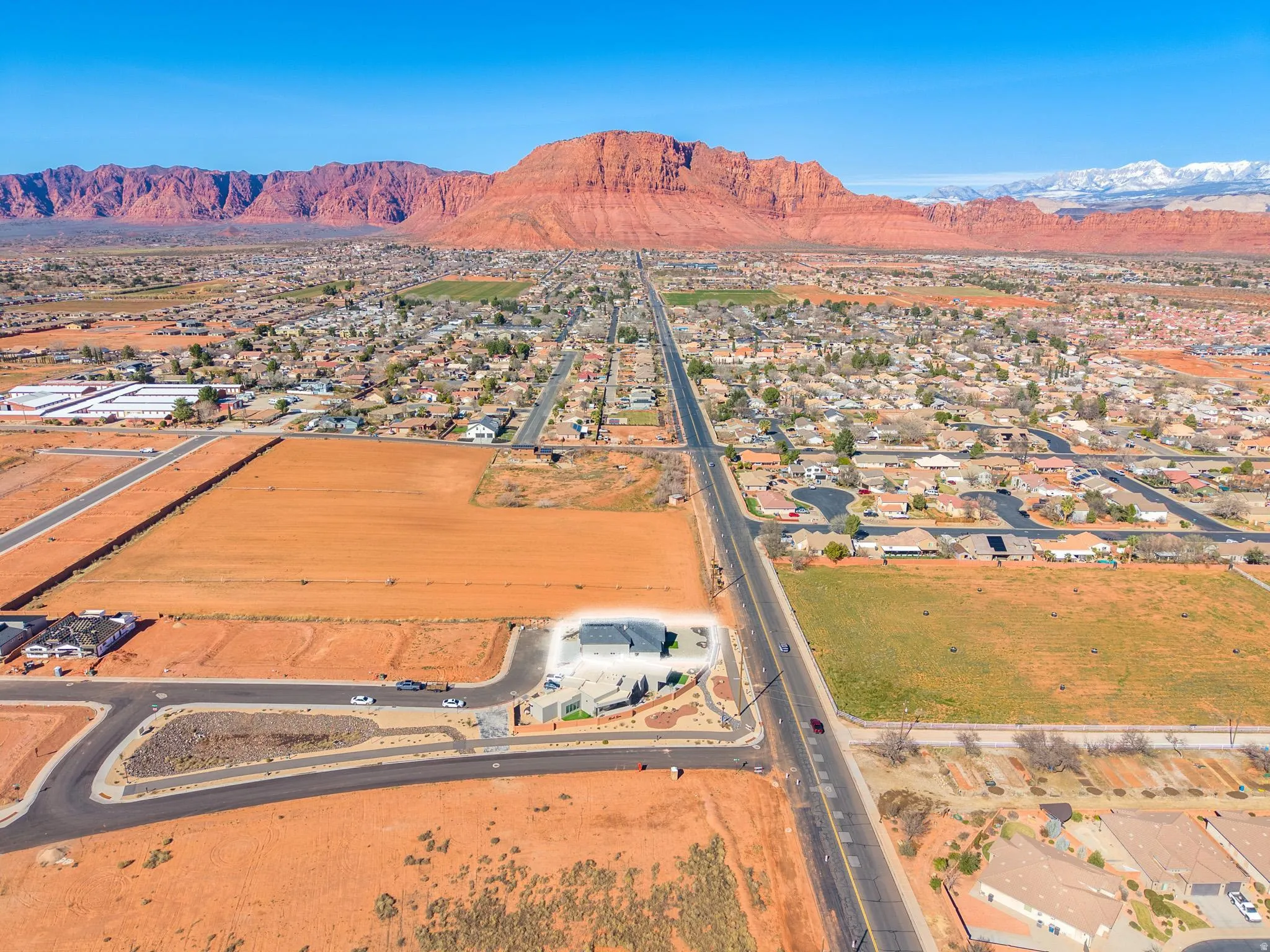 Aerial perspective of suburban area with a mountain backdrop