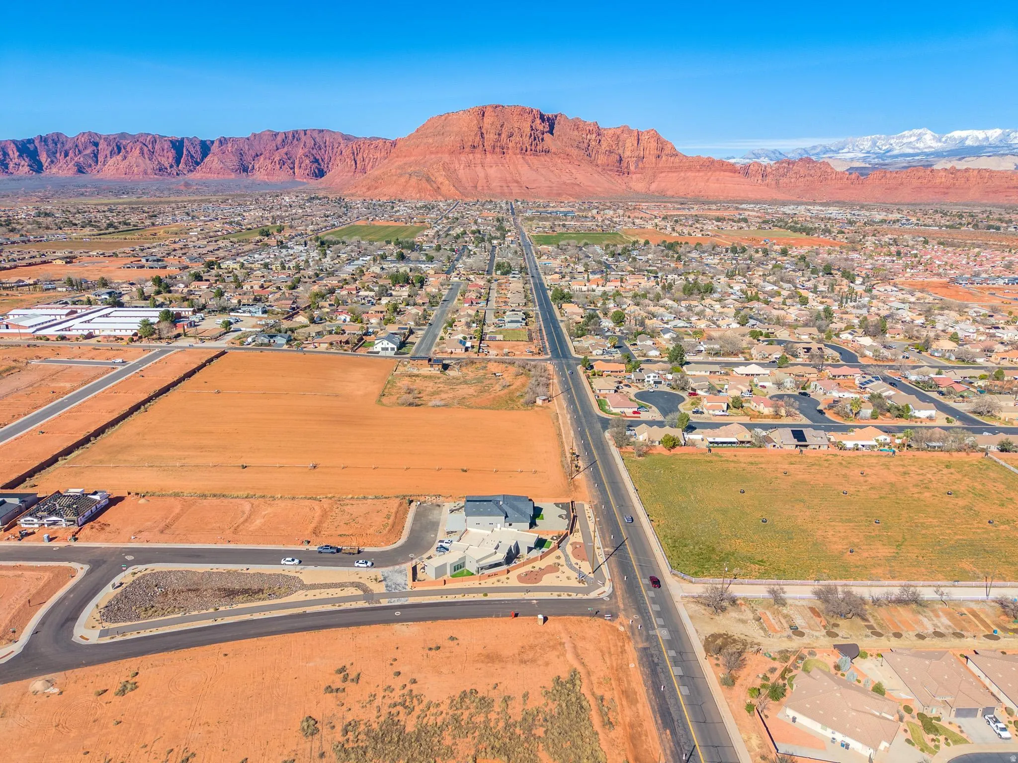 Aerial perspective of suburban area featuring a mountain backdrop
