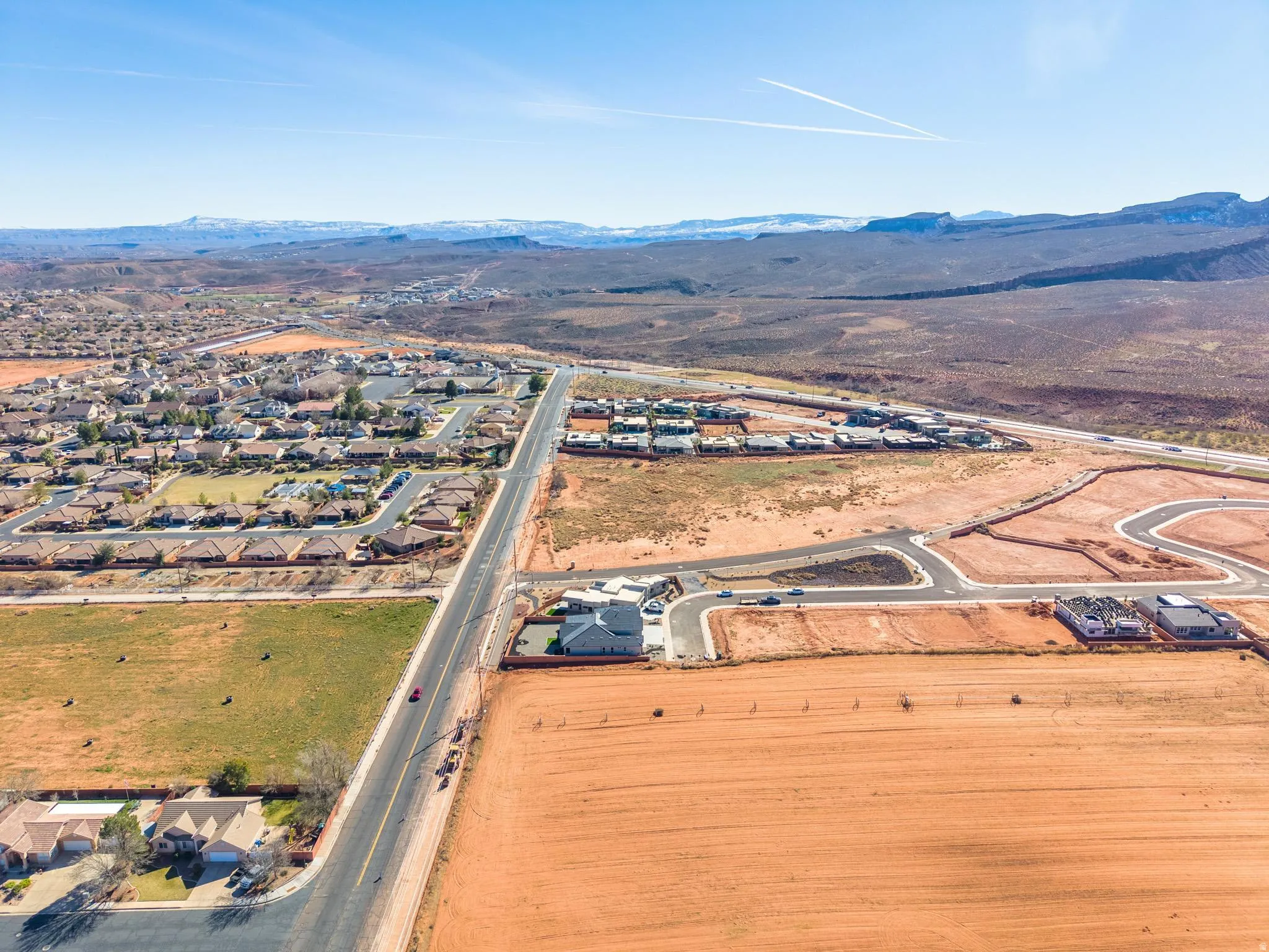 Aerial overview of property's location featuring mountains and nearby suburban area