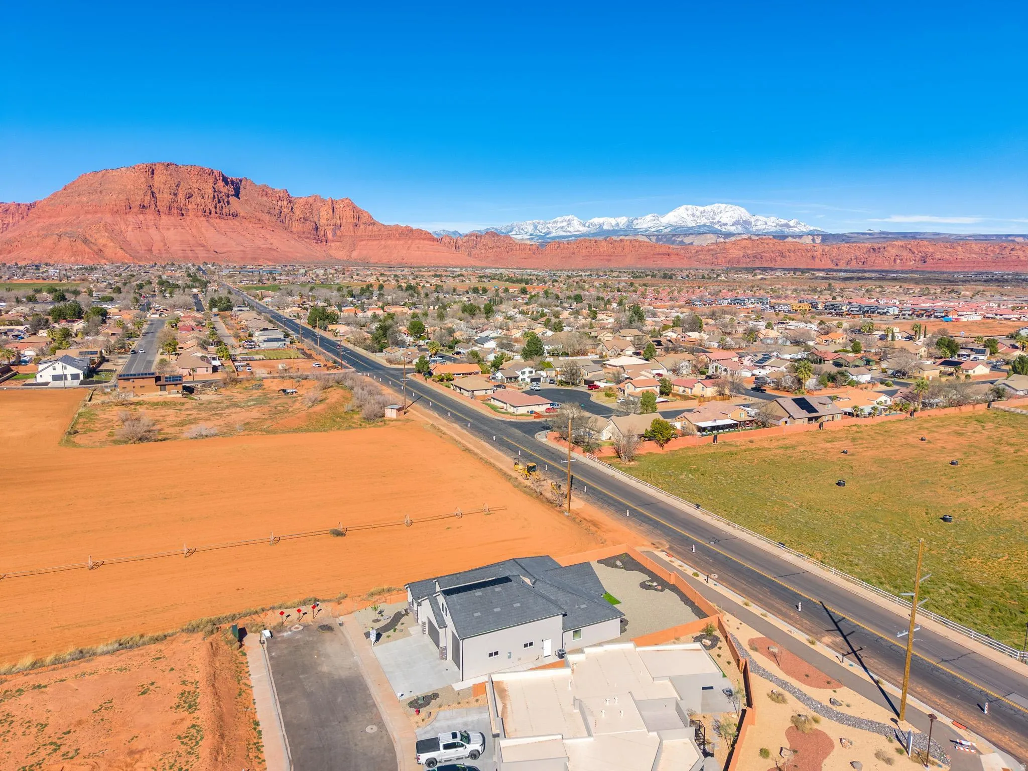 Aerial perspective of suburban area with a mountainous background