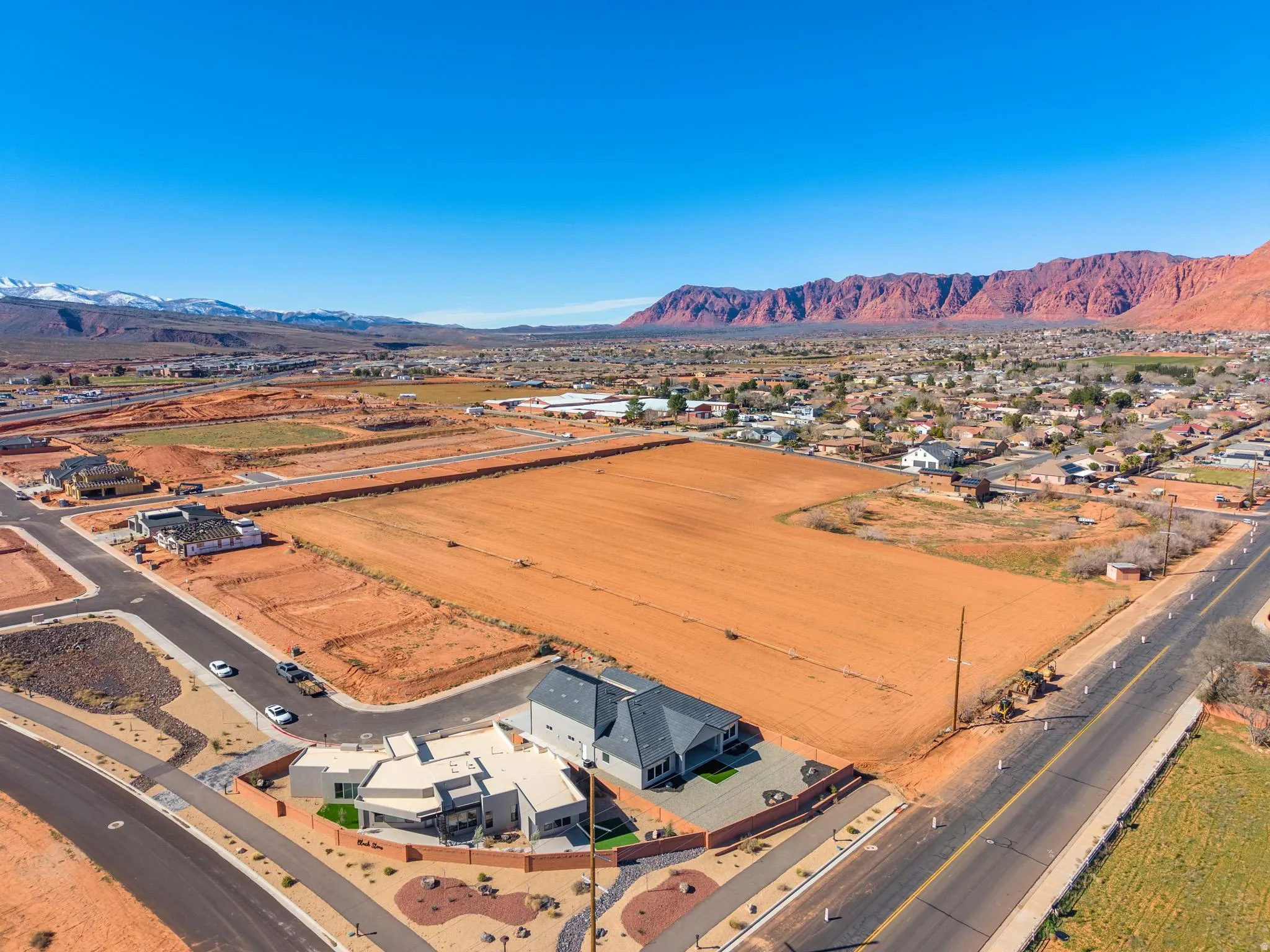 Aerial perspective of suburban area featuring a mountainous background