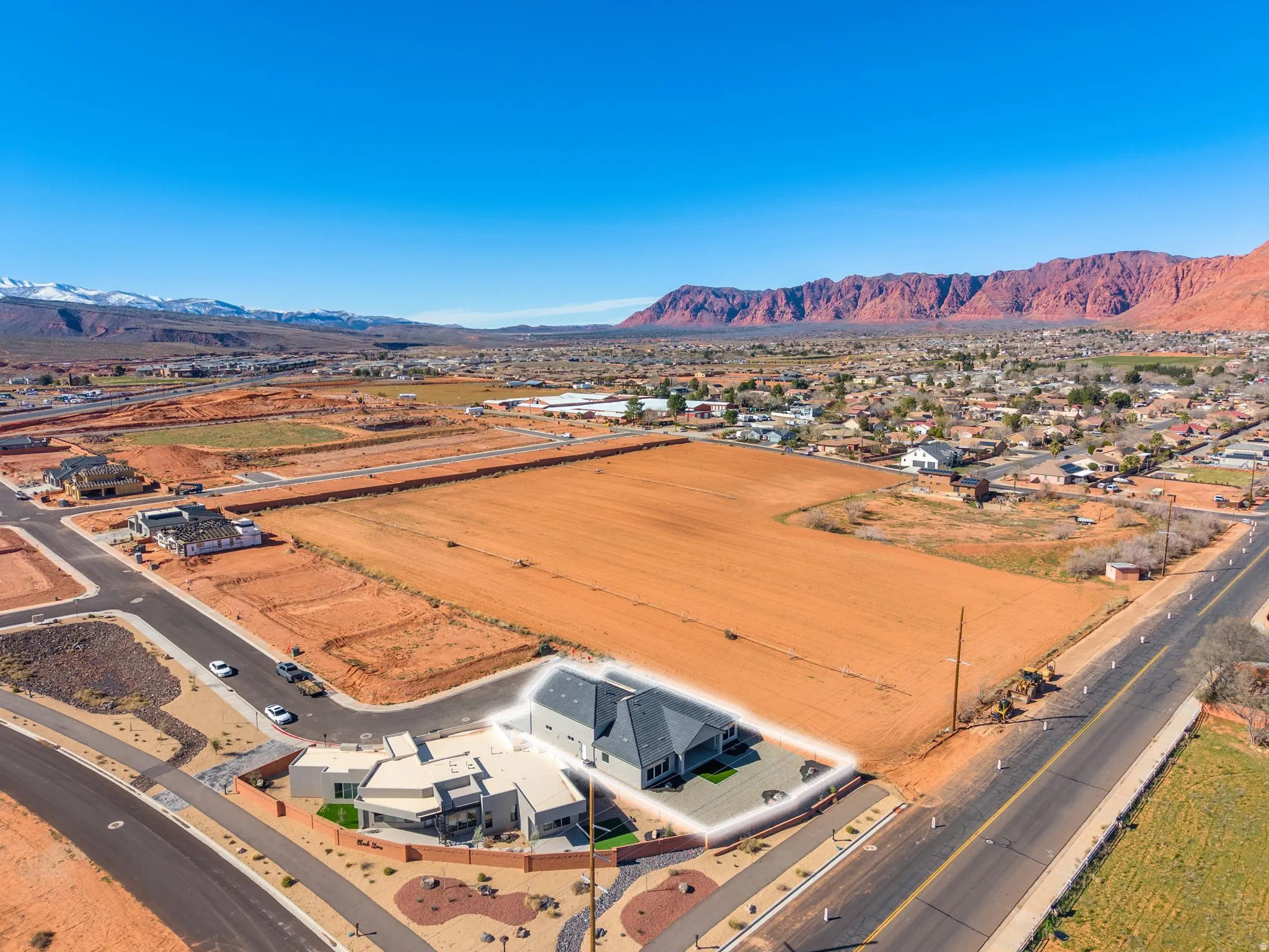 Aerial perspective of suburban area featuring a mountainous background