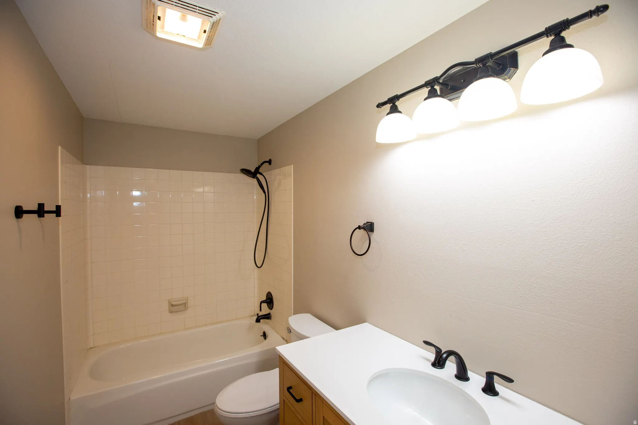 Updated full bath featuring vanity and shower / bathtub combination